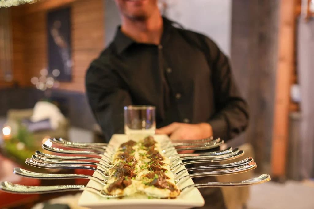 Luxury fine dining catering staff serving appetizers at a corporate event